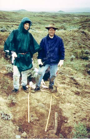 Paul and Roy digging a triceratops in the snow in June